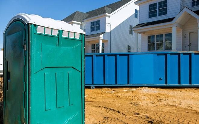portable toilet and dumpster at a construction site in New Bedford MA
